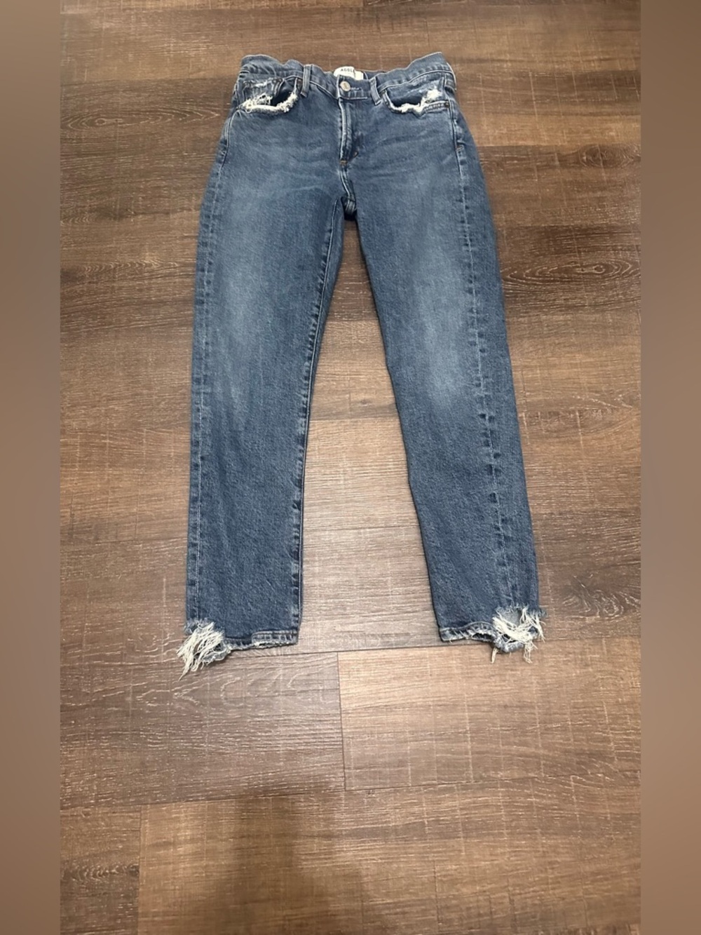 Agolde Toni Mid Rise Straight Leg model in a distressed light blue wash Size 27